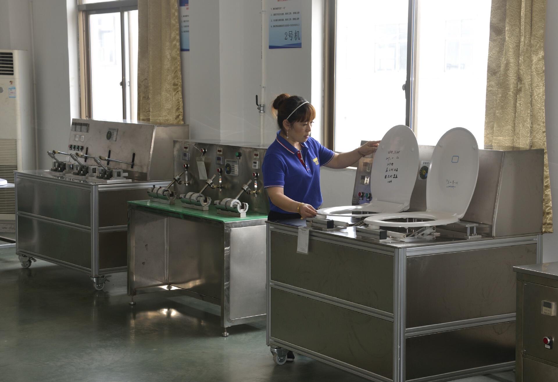 Technician testing toilet-seat closing performance